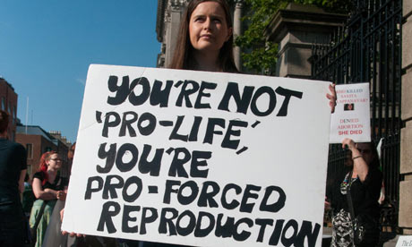 A pro-choice demonstrator stands outside the Irish parliament